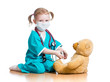 child girl with clothes of doctor playing with toy