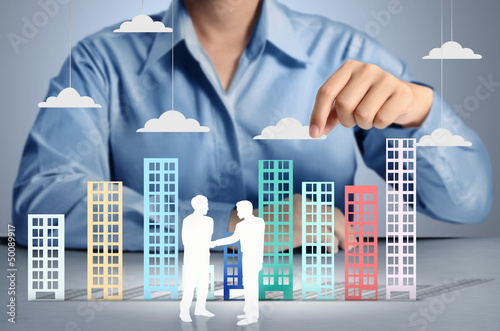 Photo: Building in hand businessmen Building in hand businessmen