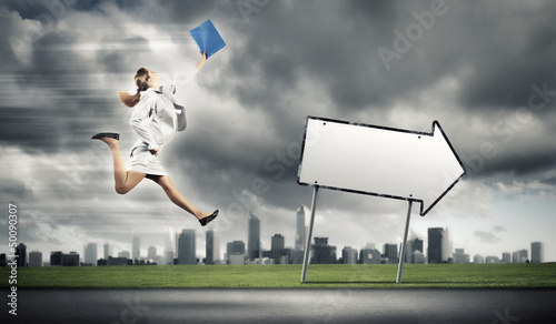 Photo: Businesswoman running on the road Businesswoman running on the road
