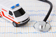Foto: Stethoscope and ambulance car on ecg Stethoscope and ambulance car on ecg