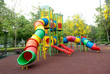 Colorful spiral tube slide at public playground .
