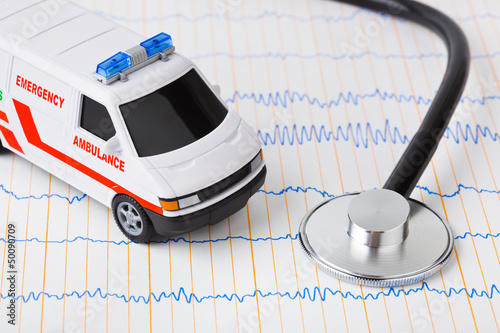 Photo: Stethoscope and ambulance car on ecg Stethoscope and ambulance car on ecg