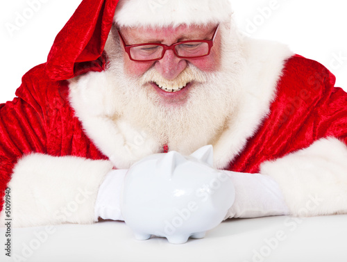 Photo: Weihnachtsmann betrachtet Sparschwein Weihnachtsmann betrachtet Sparschwein