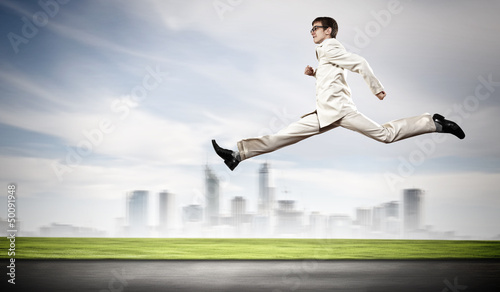 Photo: Businessman running on the road Businessman running on the road