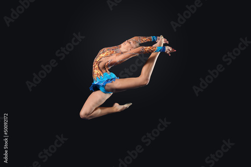 Photo: Young woman in gymnast suit posing Young woman in gymnast suit posing