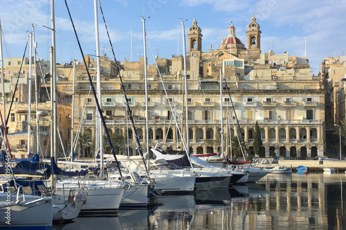 moored sailboats and waterfront of Senglea marina in front Vittoriosa, Malta 