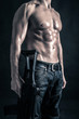 Confident young man shirtless portrait with machine gun