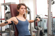 Photo: Young woman training in the gym. Young woman training in the gym.