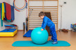 Child is therapeutic exercises in the gym