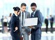 Happy business man holding a modern laptop computer