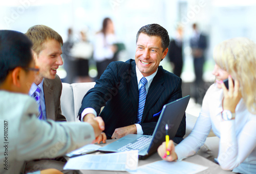 Photo: Business people shaking hands, finishing up a meeting Business people shaking hands, finishing up a meeting