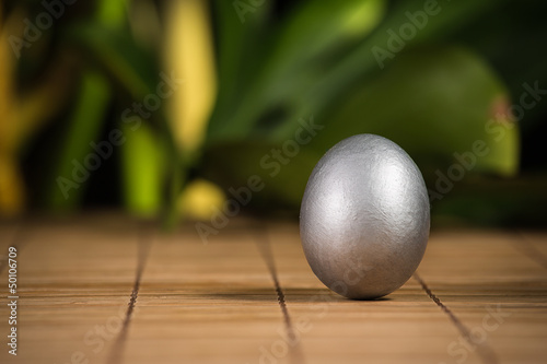 Photo: Silver Easter egg on wooden background Silver Easter egg on wooden background