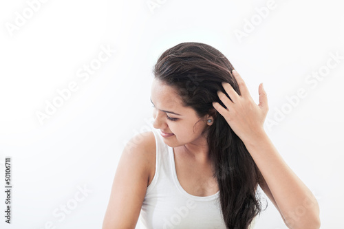 Photo: Beautiful Indian women styling her hair Beautiful Indian women styling her hair