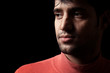 Portrait of young Indian man over dark