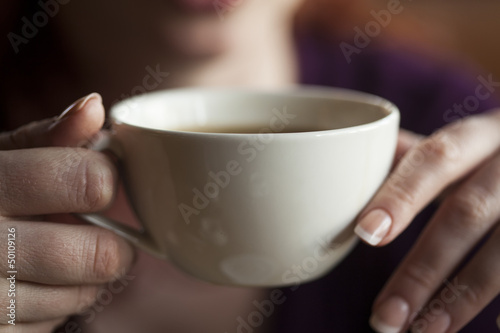Photo: Woman Holding Her Morning Cup of Coffee Woman Holding Her Morning Cup of Coffee