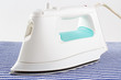 Electric steam iron on fabric surface