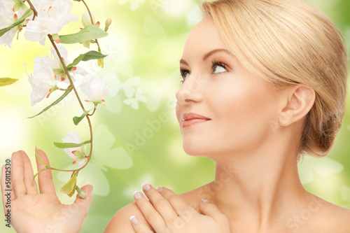 Photo: woman with flowers on twig and butterflies woman with flowers on twig and butterflies