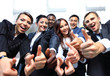 Successful business people with thumbs up