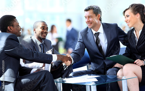 Photo: Business people shaking hands, finishing up a meeting Business people shaking hands, finishing up a meeting