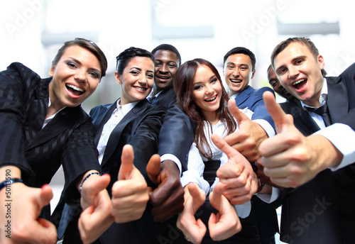 Photo: Successful business people with thumbs up Successful business people with thumbs up