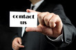 hand holding business card with the message contact us