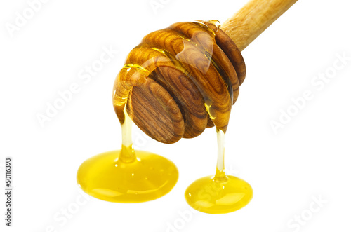 Photo: Honey dripping from a wooden of olives dipper Honey dripping from a wooden of olives dipper