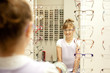a young girl choosing new glasses