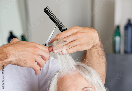 Photo: Hairdresser's Hand Cutting Hair In Parlor Hairdresser's Hand Cutting Hair In Parlor