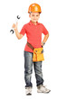 Photo: Full length portrait of a child with helmet holding a wrench Full length portrait of a child with helmet holding a wrench