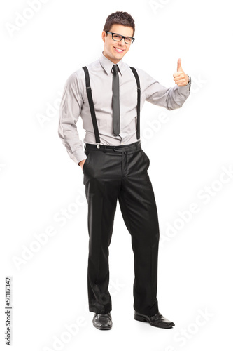 Photo: Full length portrait of a handsome man giving a thumb up Full length portrait of a handsome man giving a thumb up