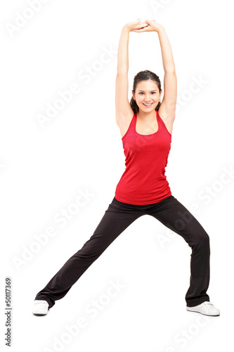 Photo: Full length portrait of a young female exercising Full length portrait of a young female exercising