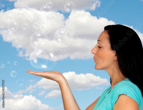 Photo: Adorable woman blowing bubbles Adorable woman blowing bubbles