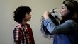 Helping Boy to Wear a Wig