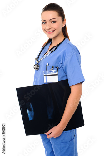 Photo: Attractive doctor holding x-ray report Attractive doctor holding x-ray report