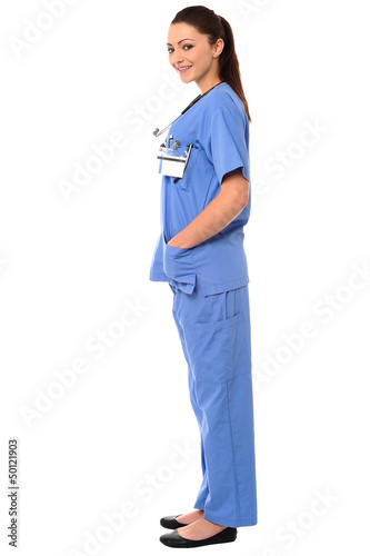 Photo: Side pose of a young female doctor in uniform Side pose of a young female doctor in uniform