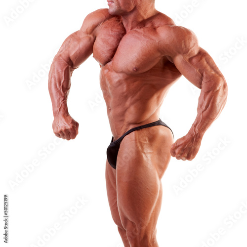 Photo: bodybuilder showing his muscles isolated on white bodybuilder showing his muscles isolated on white