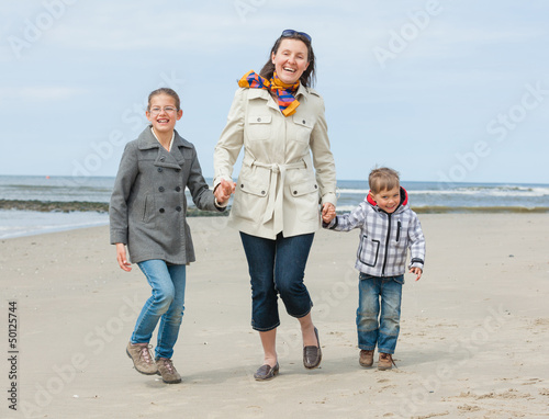 Photo: Mother and her kids at the beach Mother and her kids at the beach