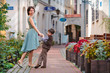 Photo: Young mother and her son walking outdoors in city Young mother and her son walking outdoors in city