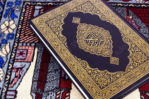 Photo: QUR'AN OVER MUSLIM PRAYER CARPET QUR'AN OVER MUSLIM PRAYER CARPET