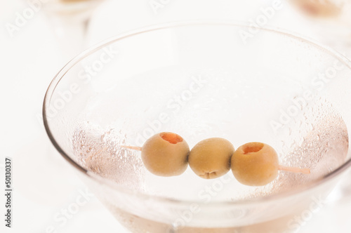 Photo: Dry Martini Cocktail with olives extreme close up Dry Martini Cocktail with olives extreme close up