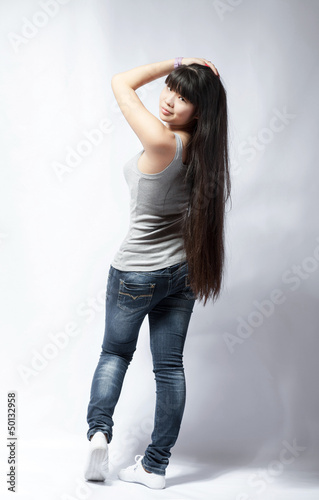 Photo: back view of standing young beautiful Asian woman back view of standing young beautiful Asian woman
