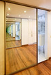Sliding-door mirror wardrobe in modern hall interior with infini
