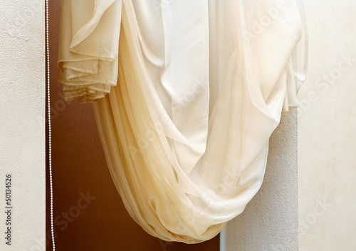 Photo: Art nouveau style curtain in window frame, interior detail Art nouveau style curtain in window frame, interior detail