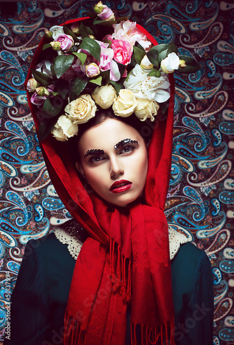Photo: Vintage. Woman in Red Shawl and wreath of Roses. Retro Vintage. Woman in Red Shawl and wreath of Roses. Retro