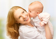 Happy cheerful family. Mother and baby kissing