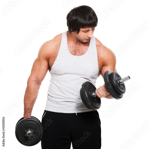Photo: Muscular guy exercises with dumbbell Muscular guy exercises with dumbbell
