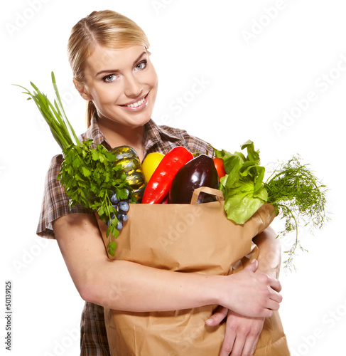Photo: Young woman with a grocery shopping bag. Isolated on white backg Young woman with a grocery shopping bag. Isolated on white backg