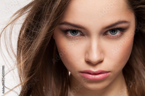 Photo: Closeup portrait of young beautiful woman Closeup portrait of young beautiful woman