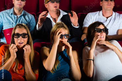 Photo: Group of people watching 3d movie at movie theater Group of people watching 3d movie at movie theater