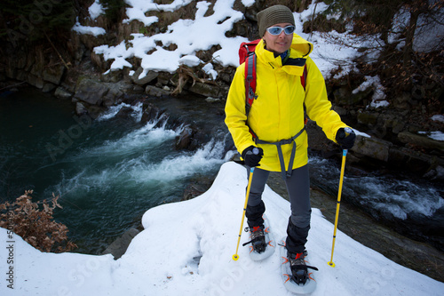 Photo: Hiking, snowshoeing - hiker in spring mountains Hiking, snowshoeing - hiker in spring mountains